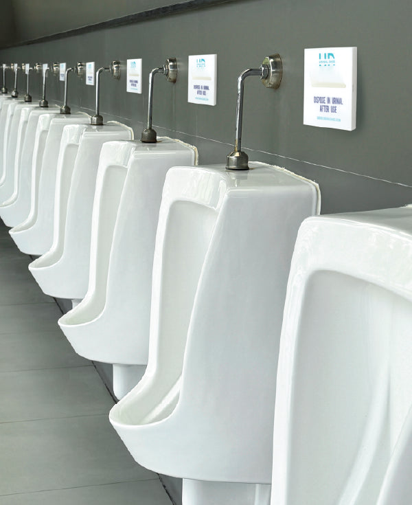 Wall-mounted Urinal Dabs dispenser for men’s restroom hygiene